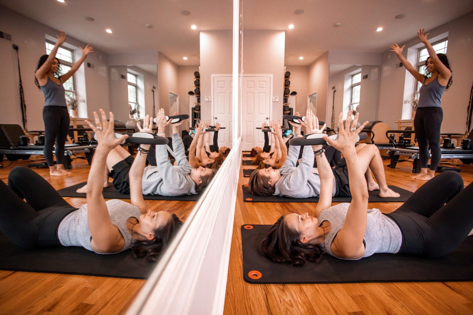 A mat class in the studio, reformers along the back wall